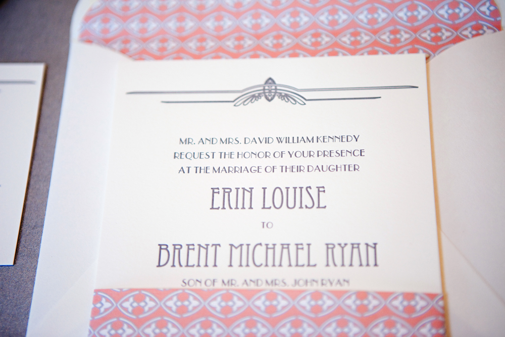 The art deco designs on the top and bottom of the invitation are a direct 
