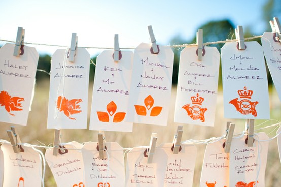 Love the use of stamps or symbols in lieu of table numbers names