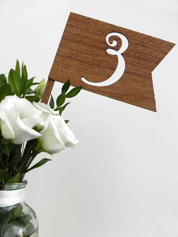 Lasercut wooden flags served as table numbers while laser engraved 