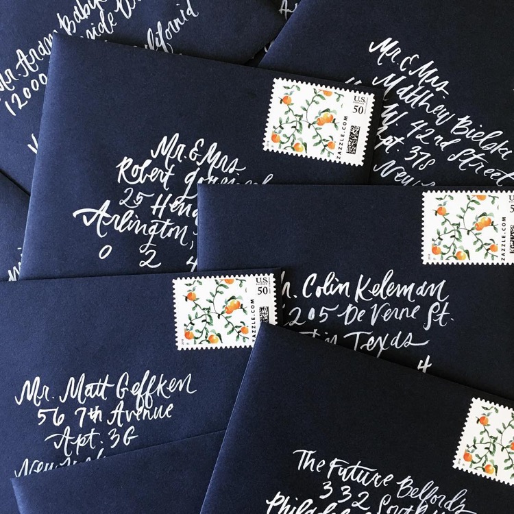 Navy Envelopes with White Calligraphy and Orange Postage Stamps by Paige and Post